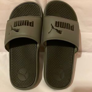 Black and gray Puma slides.